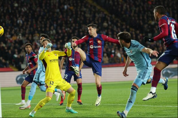 Barcelona's Brazilian forward #19 Vitor Roque (R) scores a goal during the Spanish league football match between FC Barcelona and CA Osasuna at the Estadi Olimpic Lluis Companys in Barcelona on January 31, 2024. (Photo by LLUIS GENE / AFP)