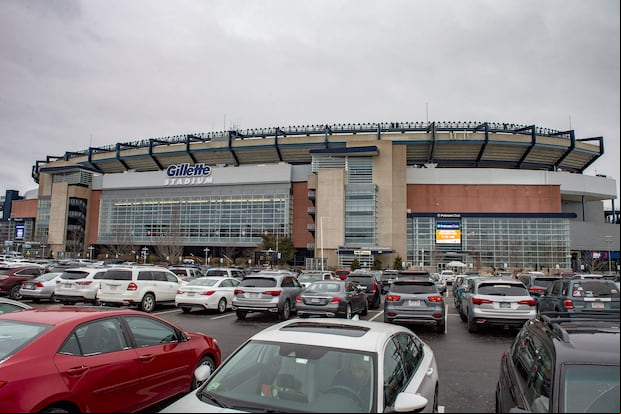 Hundreds of cars fill the car park outside the stadium as people arrive for their appointments to be inoculated against Covid-19 at Gillette Stadium in Foxborough, Massachusetts on February 1, 2021. - Mass vaccinations against Covid-19 opened to the public at Gillette Stadium as part of the beginning of "phase two" in Massachusetts with people 75 years old and older being allowed to be vaccinated. The Gillette Stadium Mass vaccination site is a partnership between the Kraft Family, CIC Health and the Commonwealth of Massachusetts. The site initially was inoculating a few hundred people a day and is now doing 2,500 people a day and working towards doing more. (Photo by Joseph Prezioso / AFP)